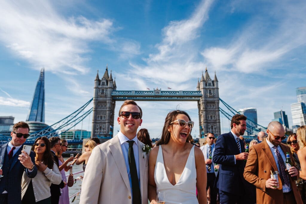 A couple laughing together after their wedding ceremony on a boat on the Thames. Sharing some of my Best of 2024 Documentary wedding Photography