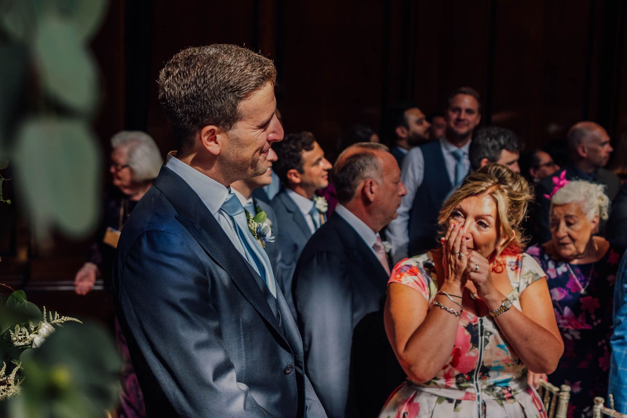 The groom seeing his bride for the first time as she walks down the aisle, captured by Merchant Taylors' Hall wedding photographer, Ben Lee.