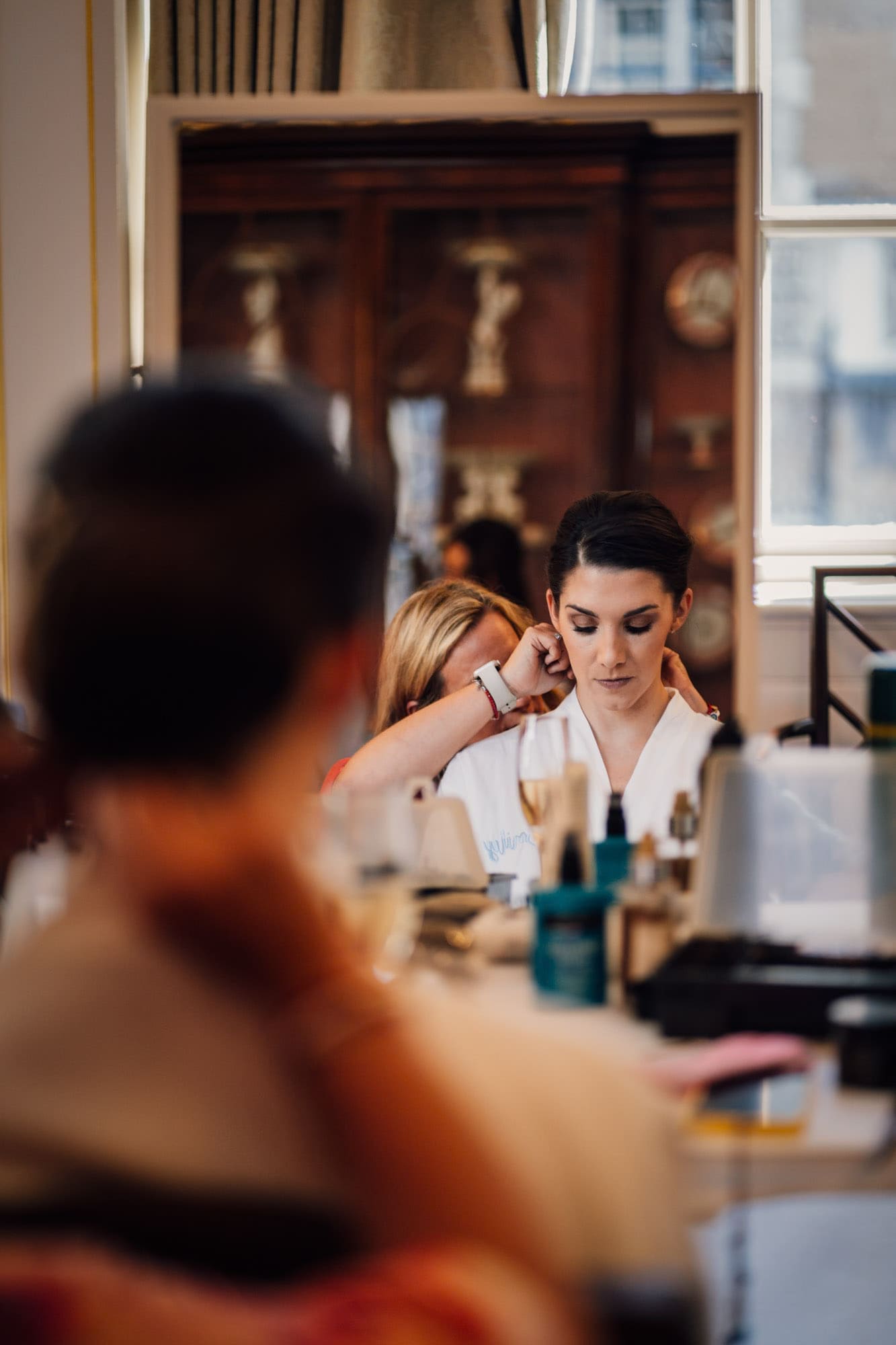bridal party preparations in a lavishly decorated room, captured in Merchant Taylors' Hall wedding photography, by Ben Lee