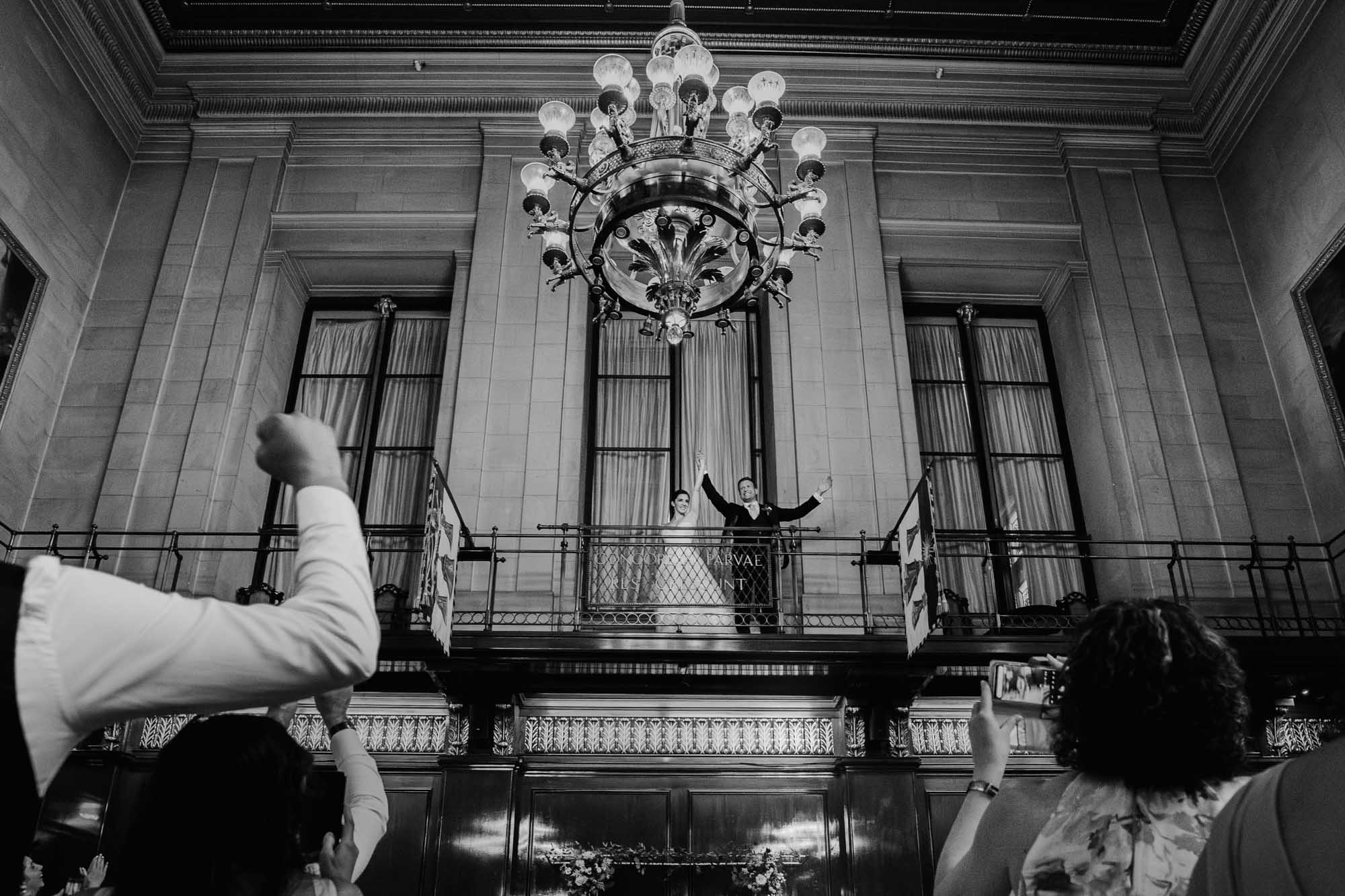bride and groom make their entrance to their wedding breakfast, captured in Merchant Taylors' Hall wedding photography, by Ben Lee