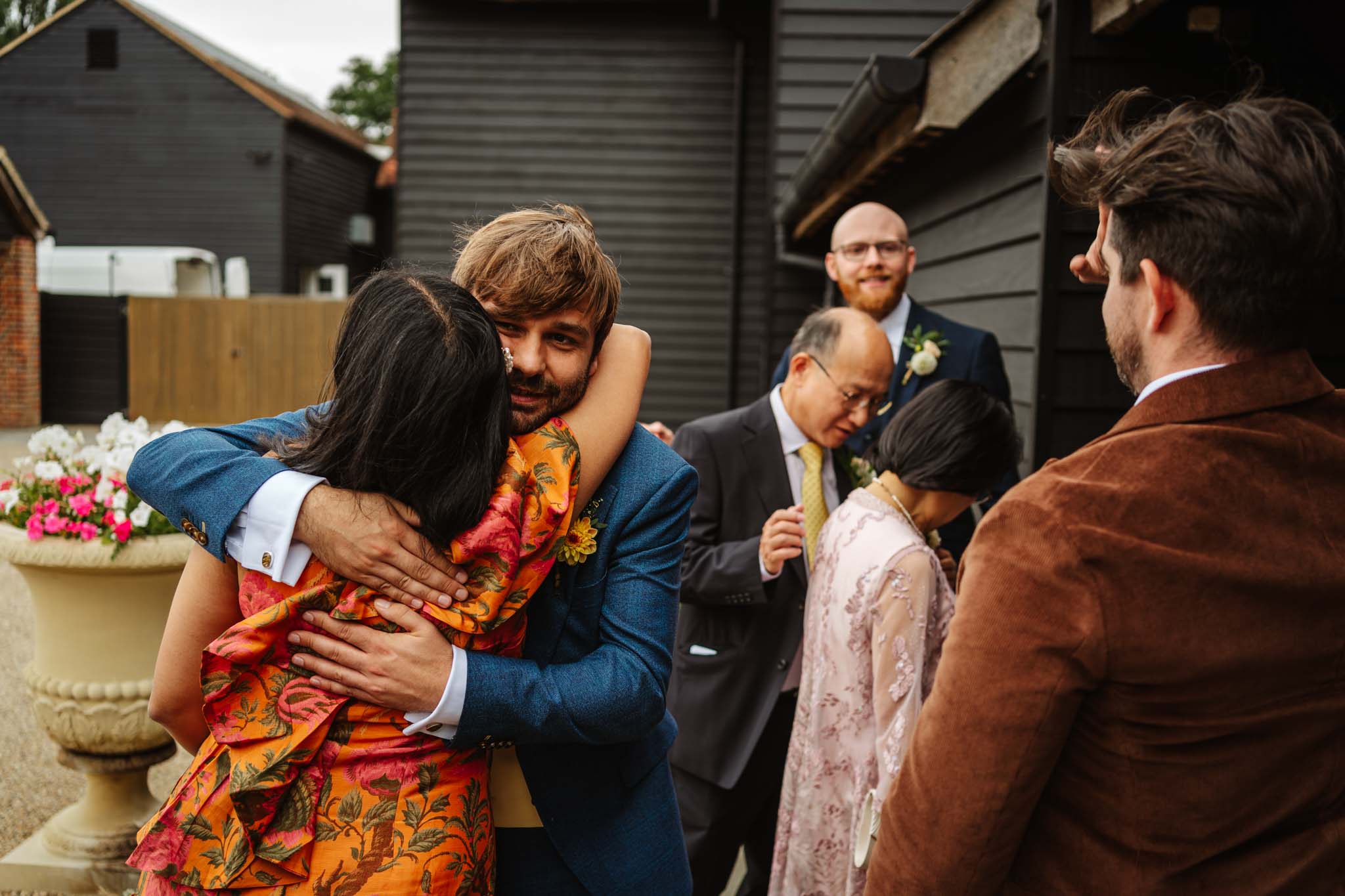 Groom greeting guests outdoors,  captured in Micklefield Hall wedding photography, by Ben Lee