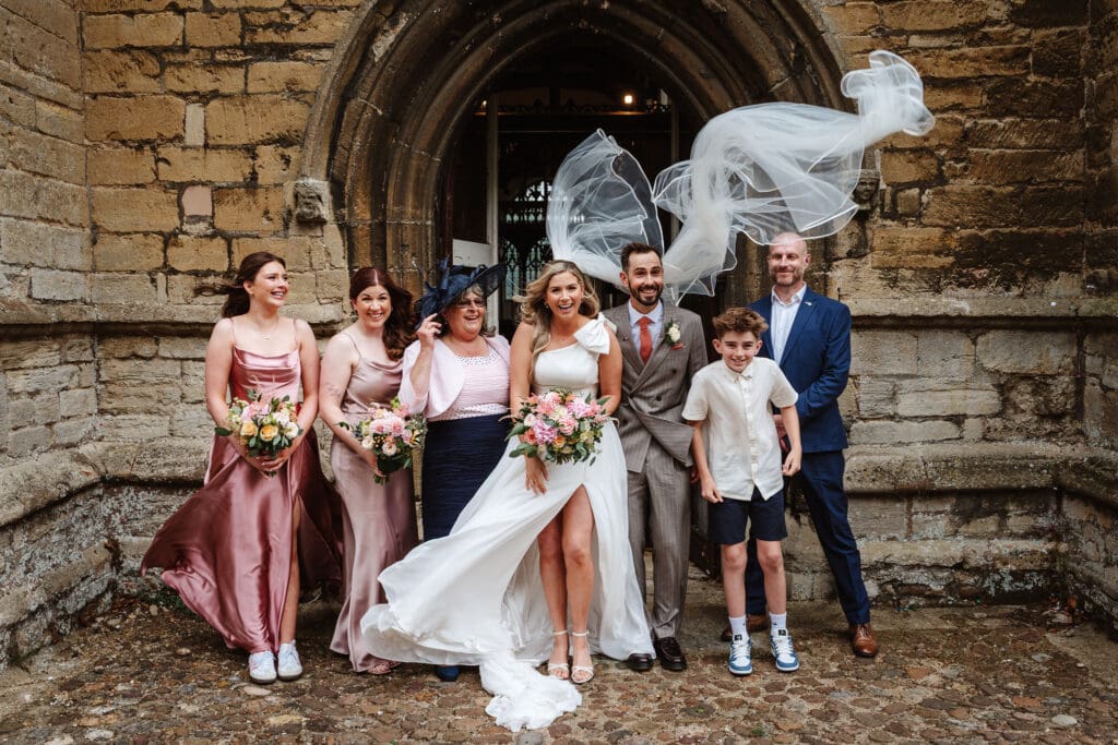 bride's veil caught in the wind by Eastfield Barn wedding photographer, Ben Lee.