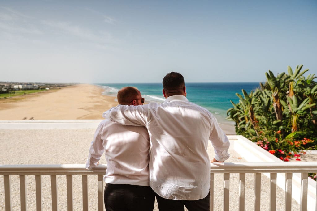 groom on the balcony of his suite captured in wedding photography in Tangier, Morocco by Ben Lee.
