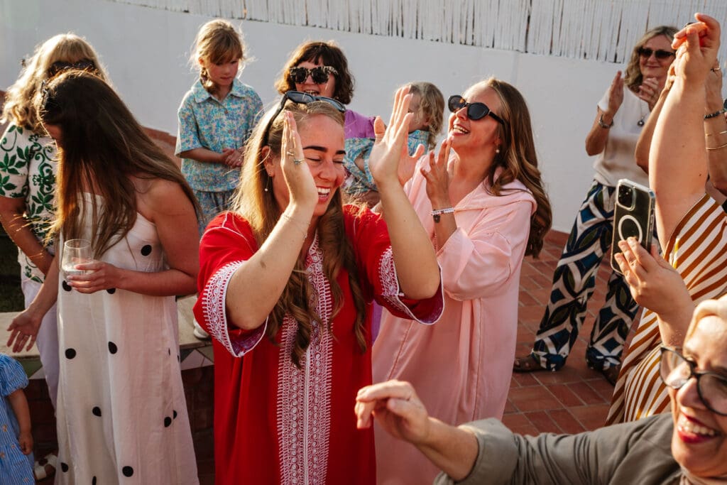 laughing and clapping captured in wedding photography in Tangier, Morocco by Ben Lee.
