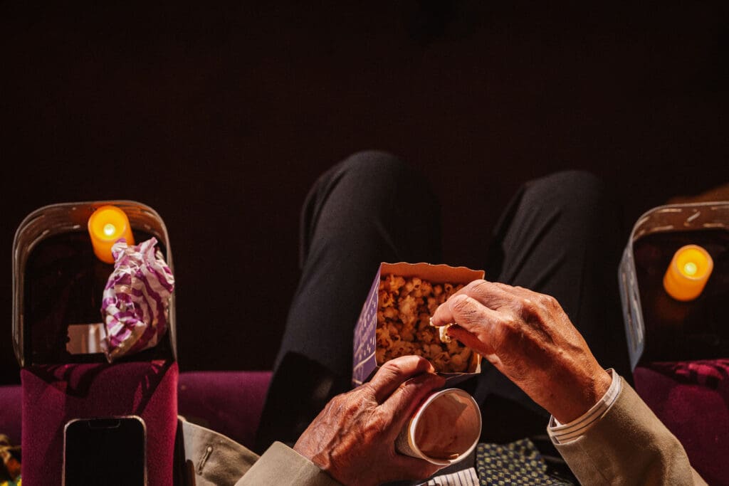 Guests enjoying popcorn and drinks at a cinema wedding in Manchester, captured by Ben Lee Photography