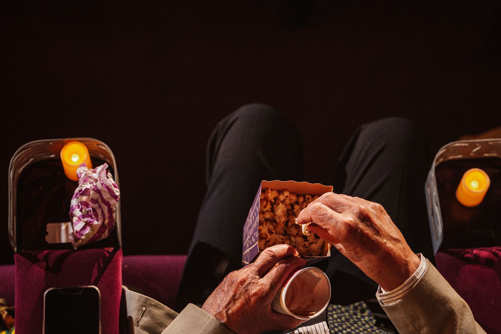 Guests enjoying popcorn and drinks at a cinema wedding in Manchester, captured by Ben Lee Photography