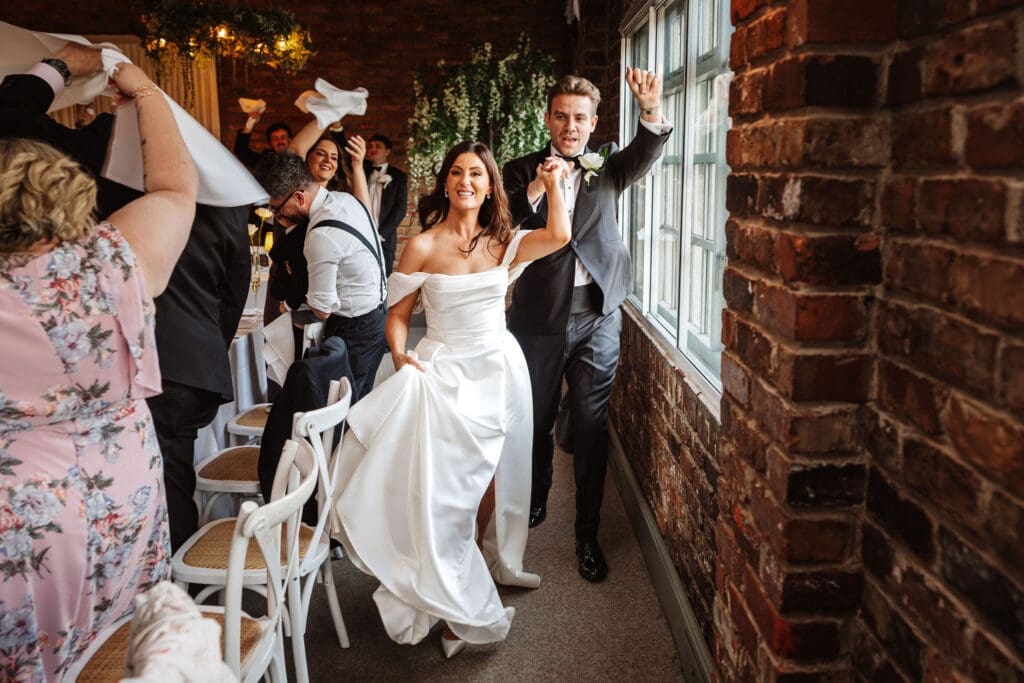 bride and groom enter ceremony at a fun wedding captured by Ben Lee Photography