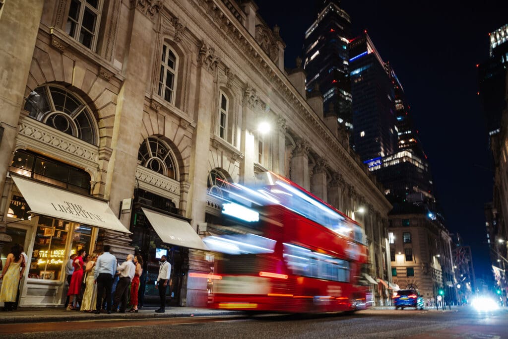 London bus street photography with guests outside wedding at the Libertine. Captured by Ben Lee Photography.